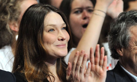 Carla Bruni listens to her husband Nicolas Sarkozy address a rally of UMP party in Paris.