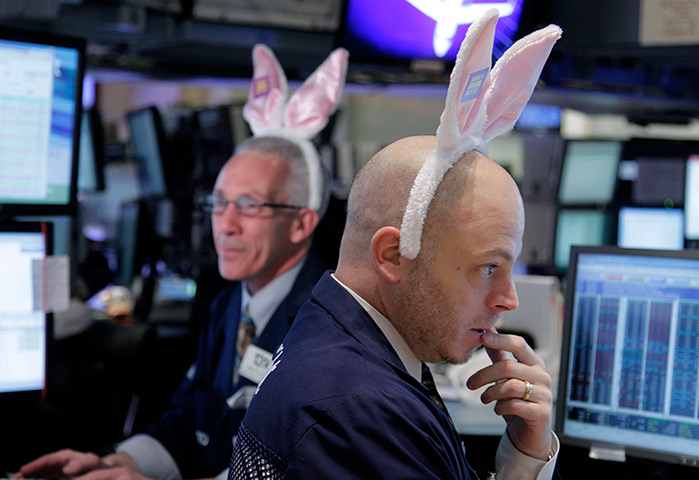 24 hours in pictures: Traders wearing bunny ears work on the floor of the New York Stock Exchange