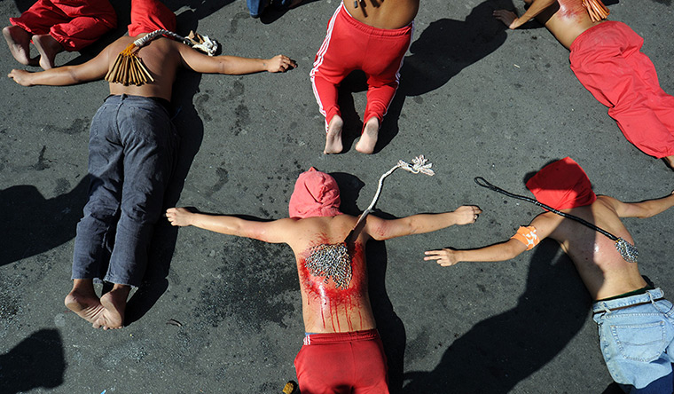 24 hours in pictures: Penitents lay on a pavement as they flagellate themselves, Manila