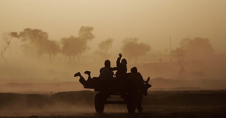 24 hours: Islamabad, Pakistan: Children riding on a donkey cart caught in a sandstorm