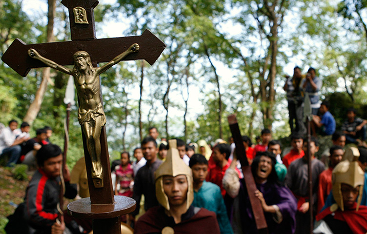 Good Friday traditions: Wonogiri, Central Java: A worshipper carries a crucifix 