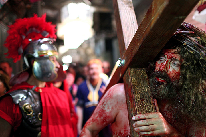 Good Friday traditions: Jerusalem: An actor representing Jesus Christ carries a cross