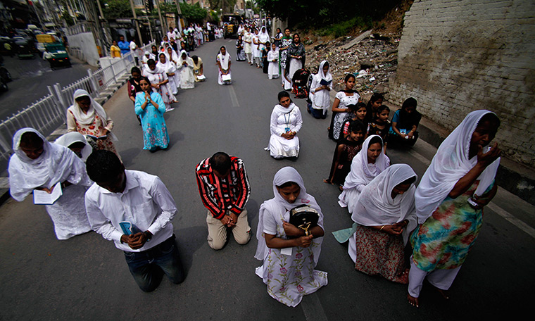 Good Friday traditions: Jammu, India: Christians kneel and offer prayers during a procession 