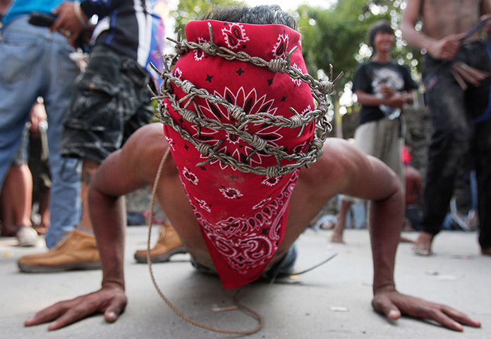 Good Friday traditions: Paombong, Philippines: A penitent wears a crown of barbed wire