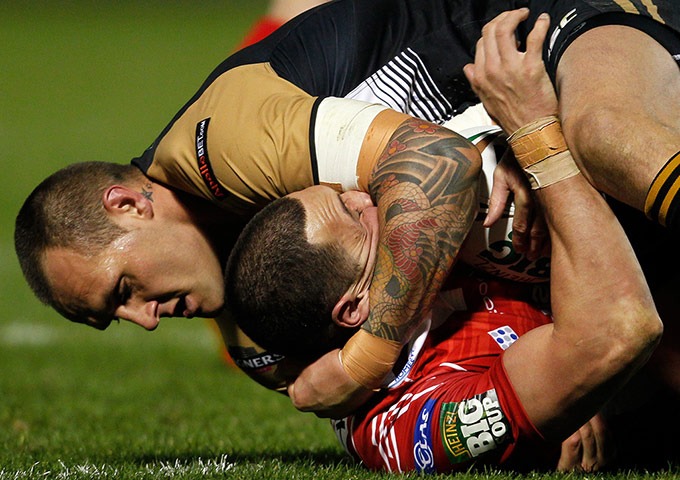 Best of the week: Wigan Warriors' Gareth Hock tackles Salford City Reds' Vinnie Anderson