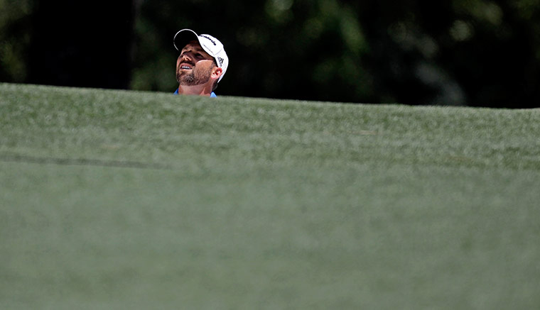 Augusta day 3: Sergio Garcia looks out from a sand trap before taking his shot on the 1st
