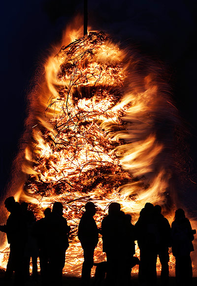 24 hours: People stand around an Easter bonfire in Elbingeroder, Germany
