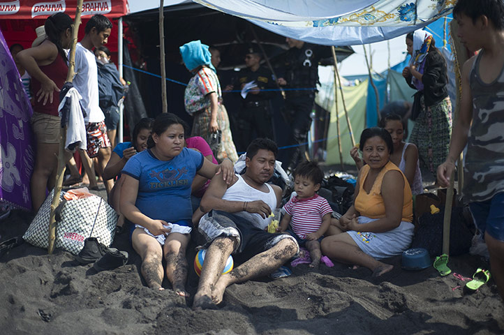24 hours: A family rests on the beach in San Jose Guatamala
