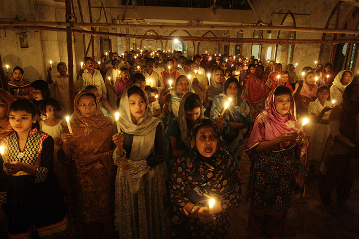 Easter Sunday: Pakistani Christians hold candles during an Easter vigil Mass