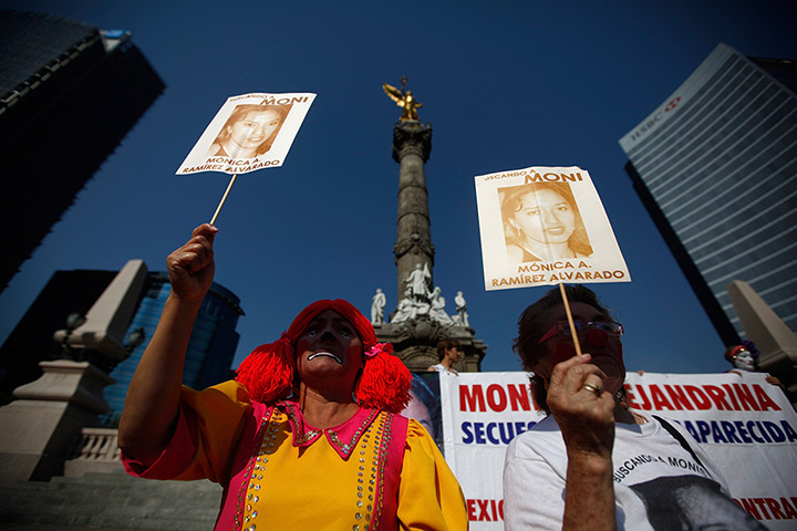 24 hours in pictures: Relatives of missing girl hold pictures during Children's Day