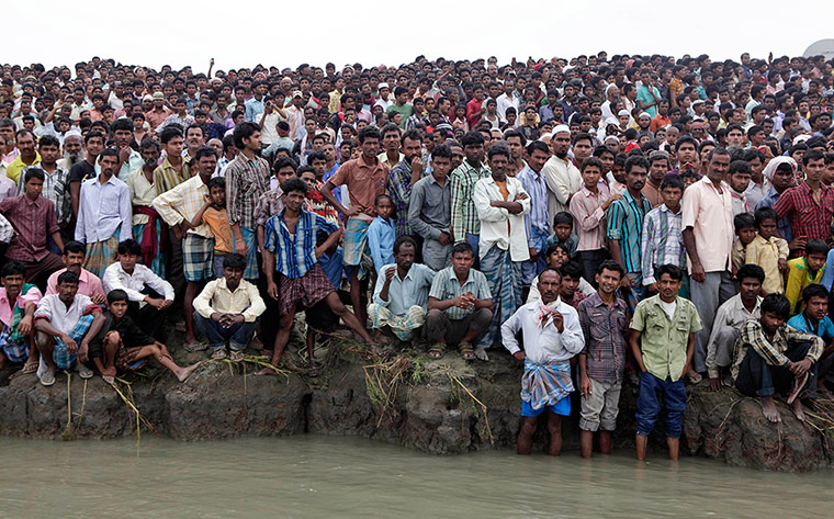 Picture Desk Live: Indian villagers watch rescue operations
