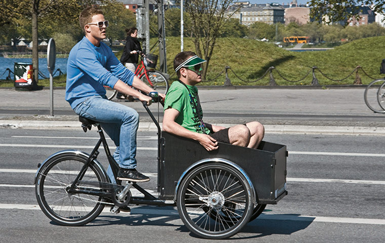 Big Picture, bikes: Big Picture: A male cycling with another male in a cart