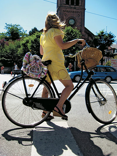 Big Picture, bikes: Big Picture: Woman wearing a yellow dress on a bike