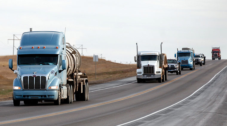 Oil in North Dakota: semi-trucks drive north on Highway 85 south of Williston