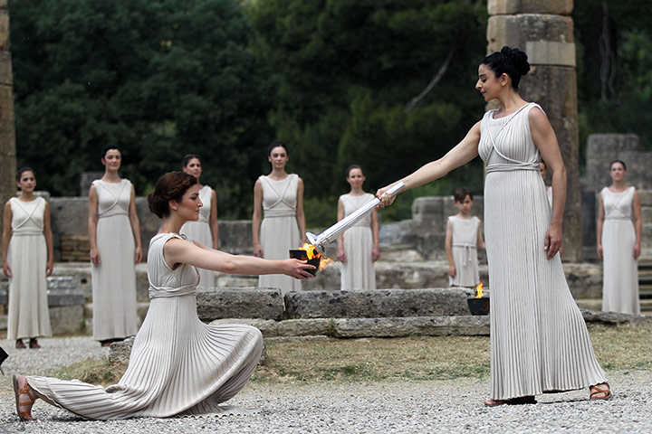 Olympic Torch: A 'high priestess' passes on the Olympic flame she has just lit