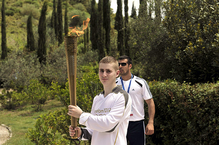 Olympic Torch: British boxer Alexandros Lucas holds the torch with the Olympic Flame