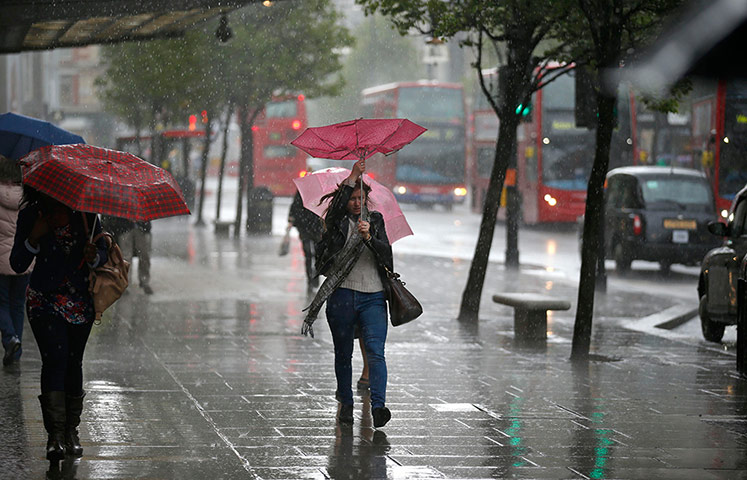 Biz week: A woman with an umbrella in the rain