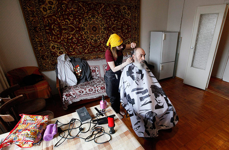 Barber: Volunteer barber and schoolgirl Katya Tsigelnikova