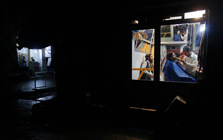 Barber: A man has his hair cut at a barber shop in Abbottabad