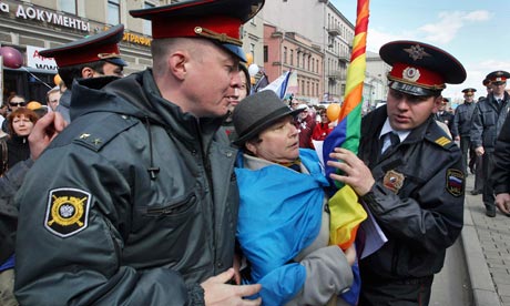 Russian police detain a gay rights activist during a protest in St Petersburg