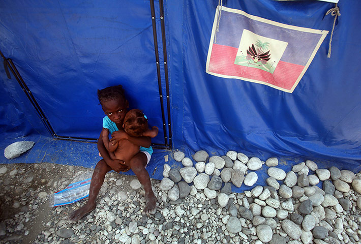 24 hours: A girl takes care of her little sister at the Marassa 14 refugees camp