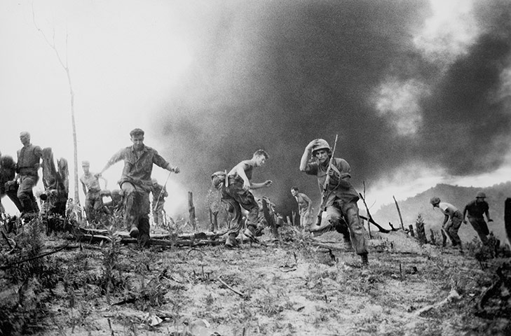 Horst Faas gallery: U.S. Marines scatter as a CH-46 helicopter burns