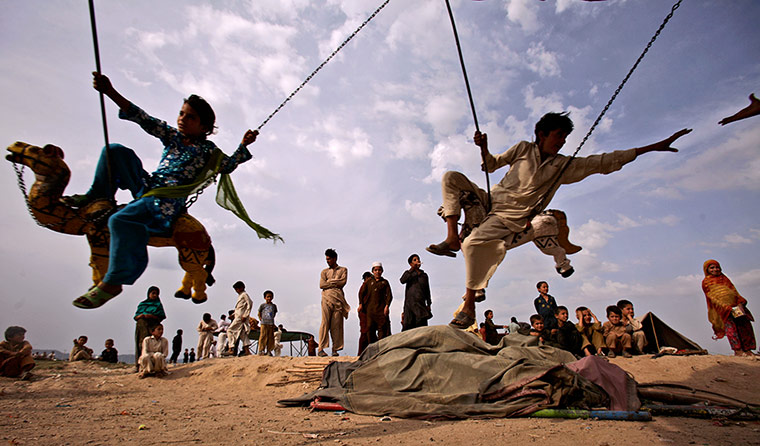 24 hours: Children play in a makeshift entertainment park in Pakistan