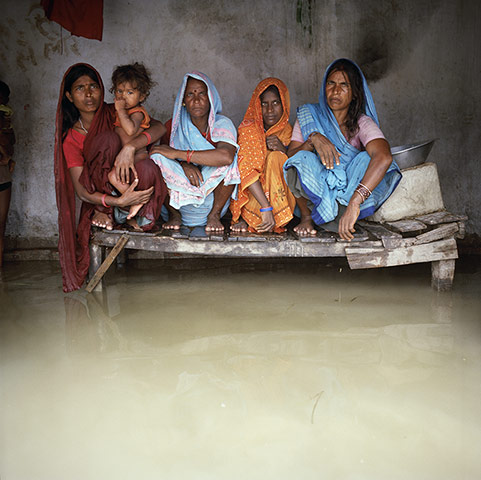 Drowning World: India - Floods - Group portrait with floodwaters