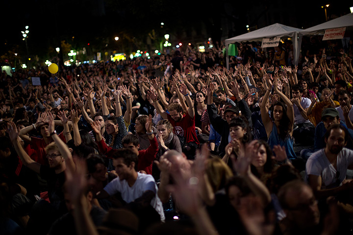 Spain protests: Demonstrators raise their hands in Barcelona, Spain
