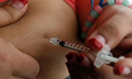 Woman injects herself with insulin