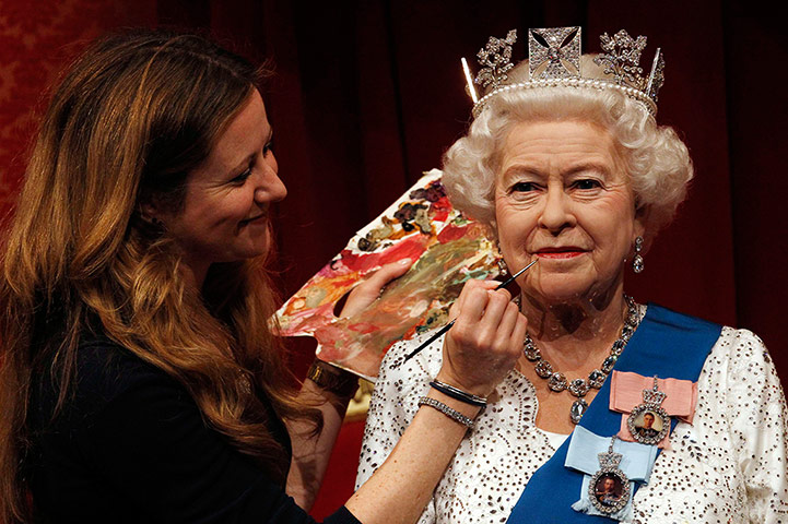 Picture desk live: A new waxwork of the Queen receives a finishing touch at Madame Tussauds