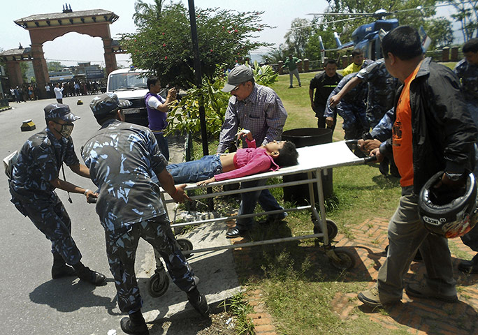 Picture desk live: A plane crash survivor is taken to hospital in Nepal