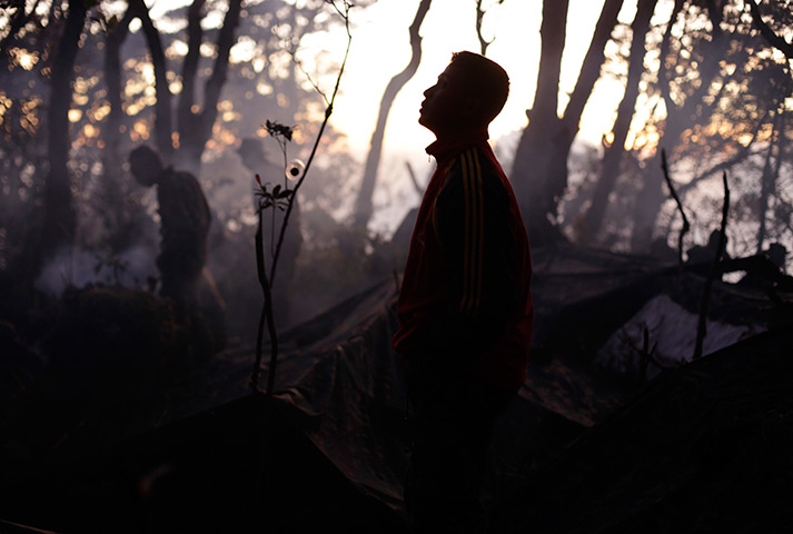 24 hours: Indonesia: An Indonesian soldier with the rescue team takes a break 