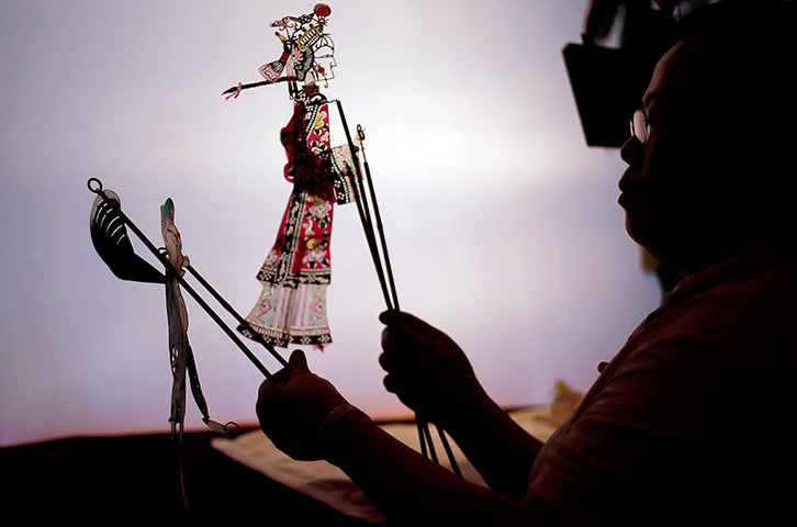 24 hours: Shanghai, China: An artist at a traditional shadow puppets