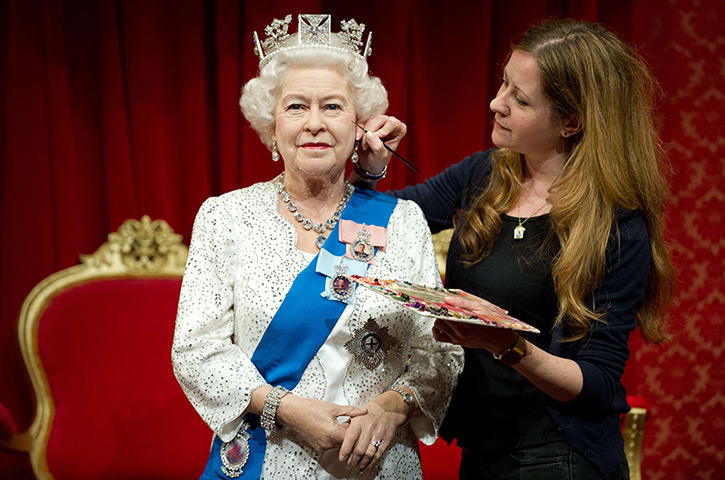 The Queen at Tussauds : 2012: Lisa Burton poses with a new waxwork figure of The Queen at Tussauds