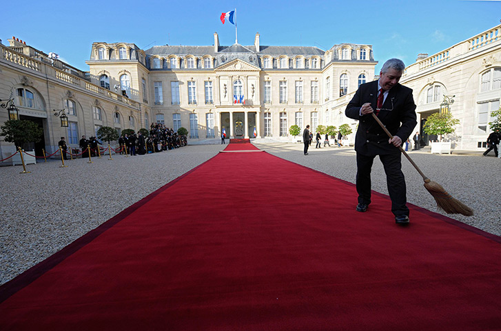 Hollande investiture : A man sweeps the red carpet in the courtyard of the Elysee Palace