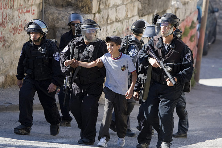 Picture desk live: t police arrest a child in Jerusalem during a protest
