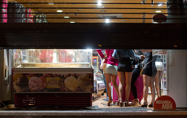 Picture desk live: Prostitutes take cover from riot police in Madrid