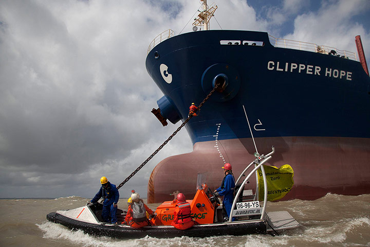 Picture desk live: A Greenpeace activist climbs towards the Clipper Hope cargo ship