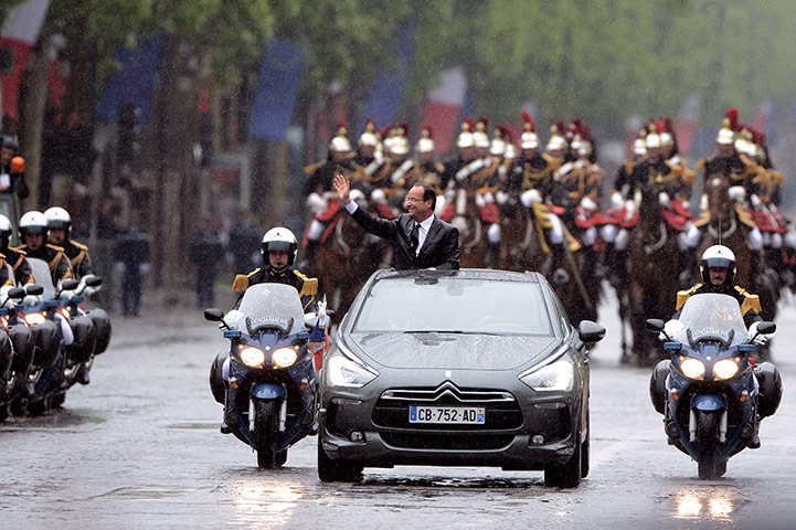 Picture desk live: The presidential parade makes its way along the Champs-Elysee