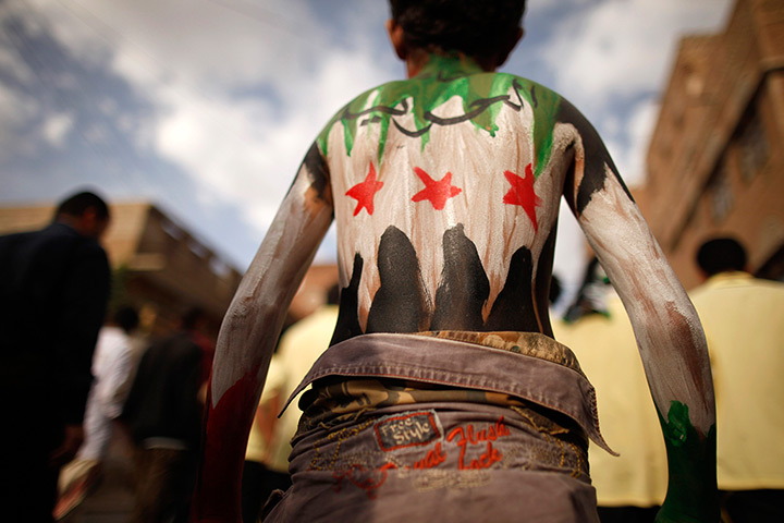 24 hours: Sana'a, Yemen: A youth painted with the colours of Syria's opposition