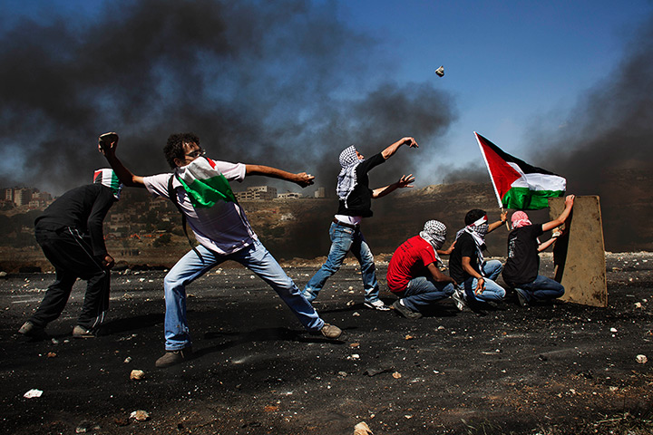 24 hours: Ramallah, West Bank: Masked Palestinians hurl stones at Israeli troops 