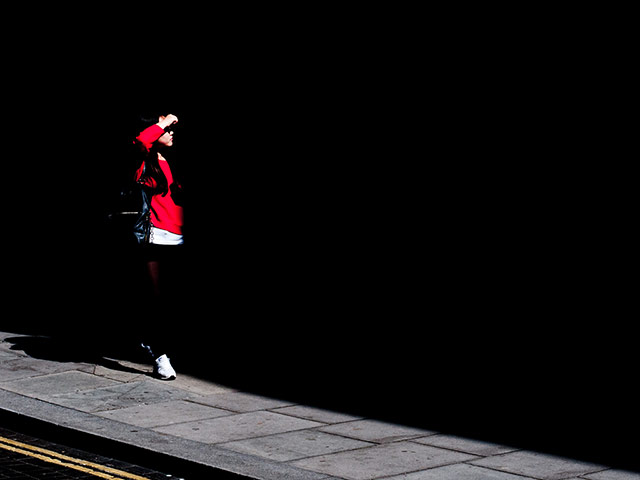 Your Pictures: Your Pictures: Girl wearing red, highlighted on black background by the sun