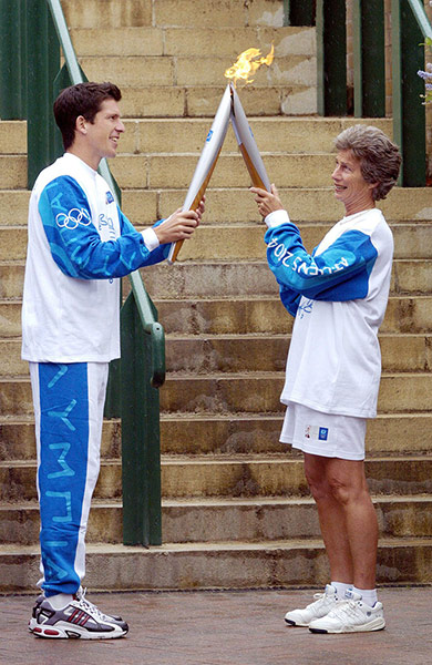 Olympic fashion: Olympic Torch Relay, 2004: Tim Henman hands flame to Virginia Wade