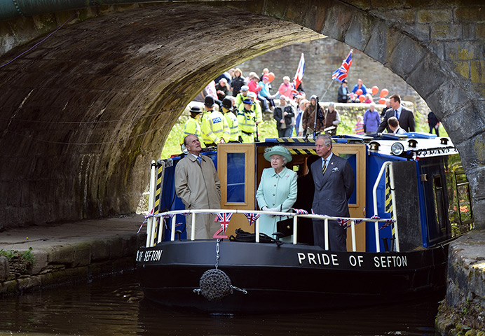 Picture desk live update: Queen Elizabeth, Prince Philip and Charles travel on a canal boat, Burnley