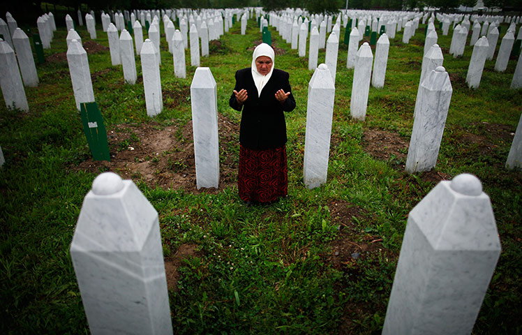 Picture desk live: Mejra Dzogaz at the graves of her sons killed in the Srebrenica massacre