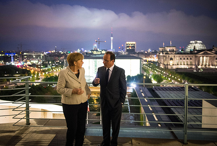 24 hours in pictures: Merkel And Hollande Meet Hours After Hollande's Inauguration