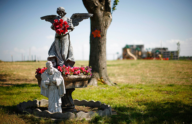 24 hours in pictures: Statues are seen with flowers in Joplin