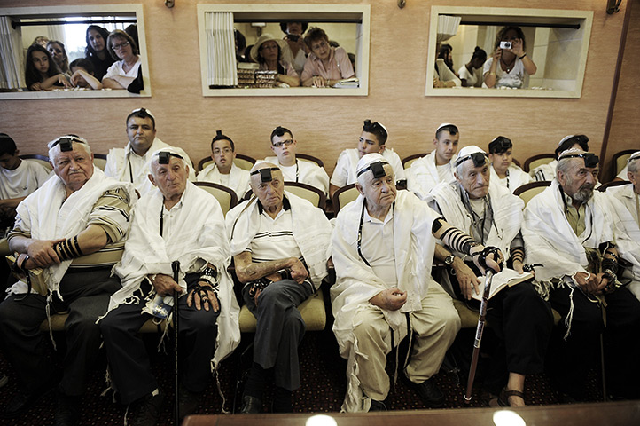 24 hours in pictures: Holocaust survivors sit in a synagogue during a Bar Mitzvah ceremony