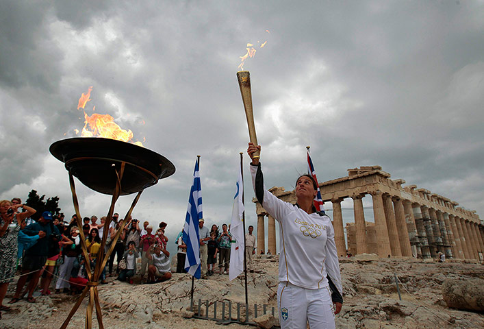 Picture desk live: Greek athlete Niki Liosi lights her Olympic torch in Athens
